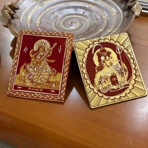 Red and Gold Saraswati Devi and Shiv Parvati 
Pictures made of metal.